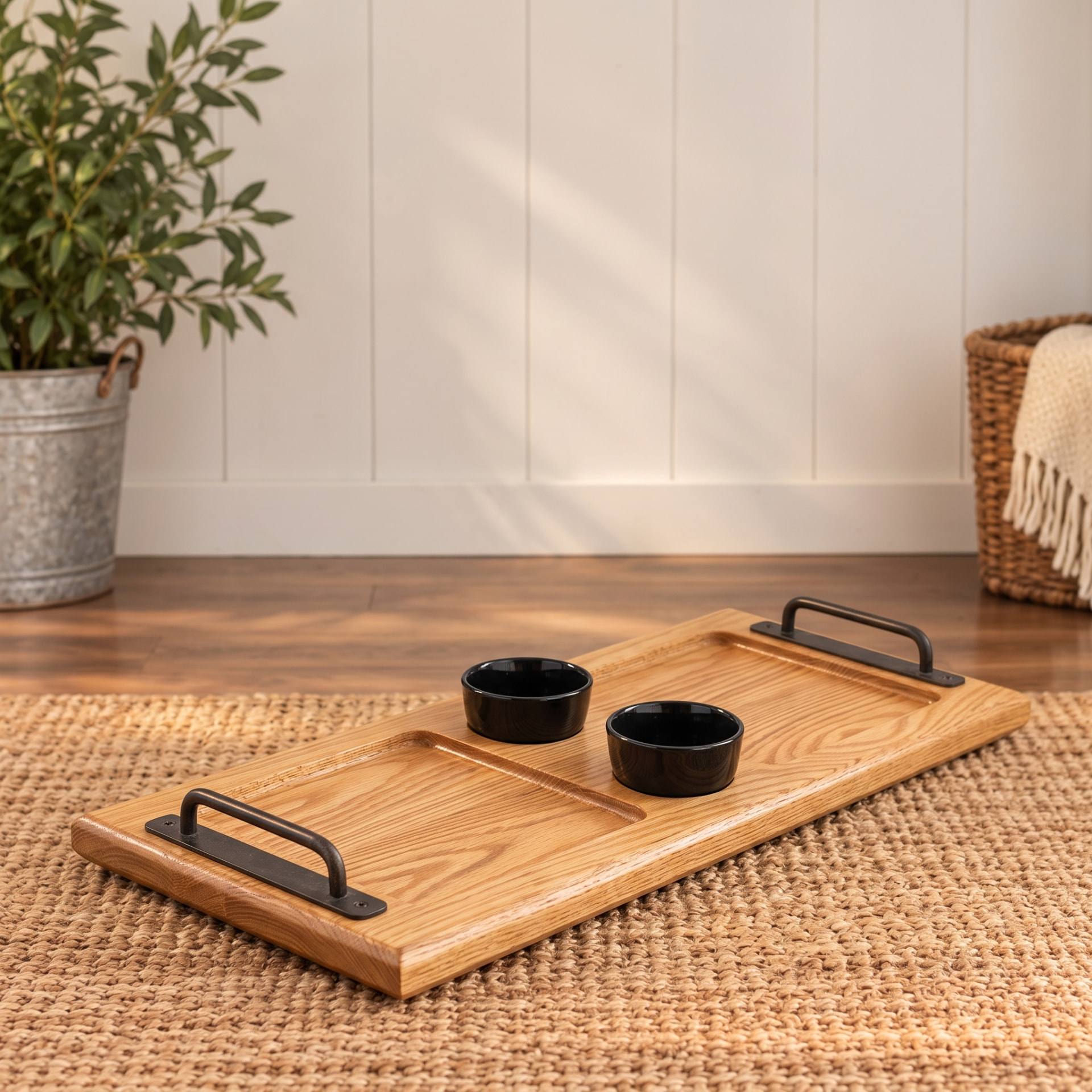 White oak serving board with iron handles and two black bowls